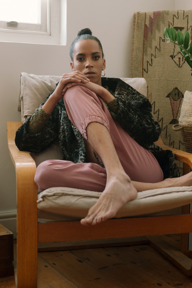 a person sitting in a chair with their legs crossed